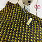 Tissu Wax africain, motif écailles jaunes et bordeaux sur fond noir – coupon 3 yards.